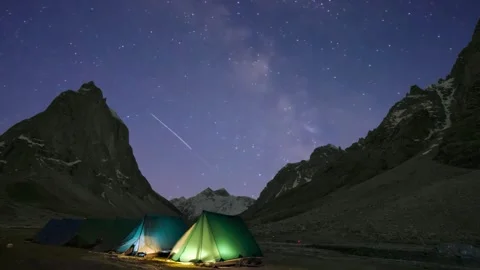 Starry Night Time-Lapse in Himalayan Mountains with Illuminated Campsites Stock Footage 313807661