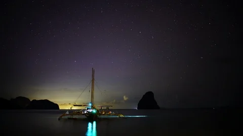Starry night timelapse in Palawan with trimaran sailboat Philippines Stock Footage 124997483