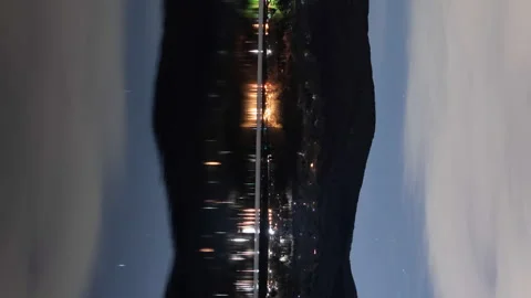 Starry Sky and Traffic Reflected in a Lake at Night (Vertical, Time Lapse) Stockbeeldmateriaal 147964372