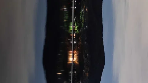 Starry Sky and Traffic Reflected in a Lake (Vertical/Time Lapse/Panning) Stock Footage 147968966