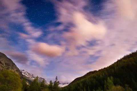 The starry sky with blurred motion clouds and bright moonlight, captured from Stock Photos