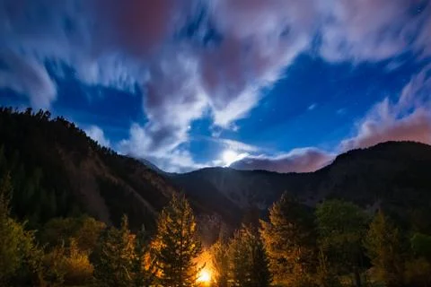 The starry sky with blurred motion clouds and bright moonlight, captured from Stock Photos