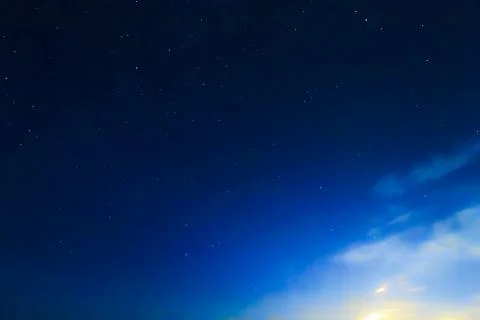 The starry sky at dawn. Yellow rays of the sun Stock Photos