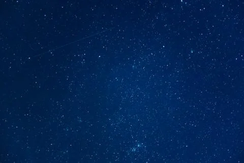 Starry sky at night with falling star. Astrophotography background Stock Photos