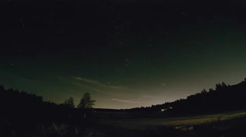 Starry Sky Turning Over a Moonlit Field Stock Footage 62493510