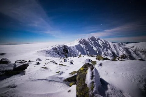 Starry winter night on the mountains. Inversion and clouds in a valley. Low T Stock Photos