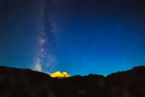 Stars and clouds over Mount Elbrus. Watercolor illustration. Night landscape. イラスト素材