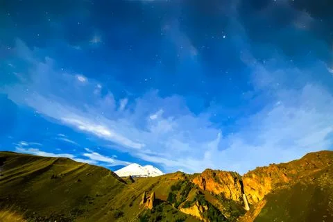 Stars and clouds over Mount Elbrus. Watercolor illustration. Night landscape. イラスト素材