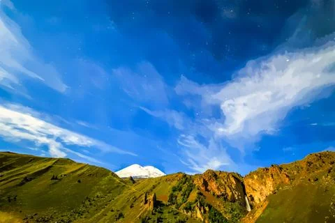 Stars and clouds over Mount Elbrus. Watercolor illustration. Night landscape. イラスト素材