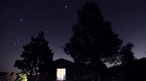 Stars behind cabin with trees time lapse Stock Footage 8994134