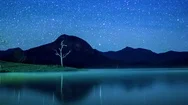 Stars Moving Over Mountains And Wanaka Lake At Night Stock Footage