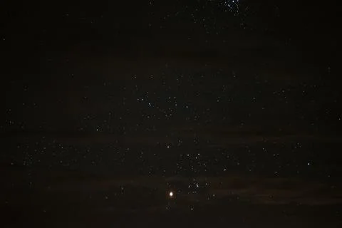 Stars in the night sky through the clouds on a summer night Stock Photos