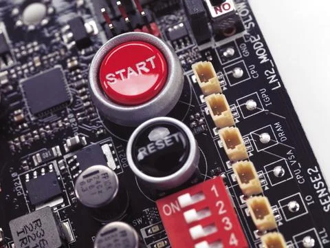 Start and Reset buttons on computer motherboard closeup on white background Stock Photos