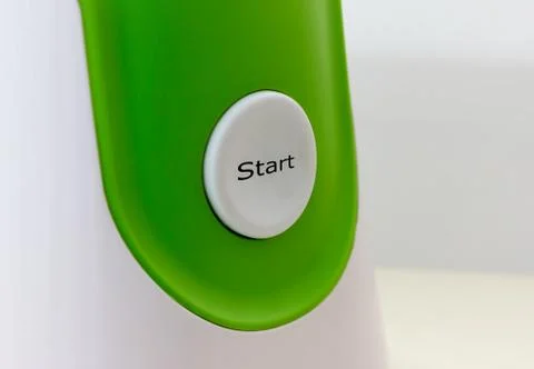 Start button on the white-green background Fotos de archivo