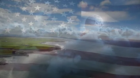 On start camera panning coast, faint American flag appearing and rippling Stock Footage 329505123