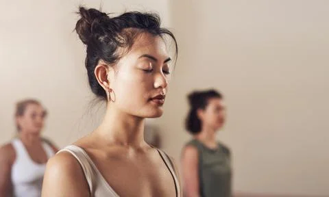 Start connecting more with your inner self. an attractive young woman meditating Fotos Stock