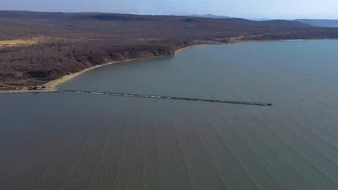 Start of construction of a low-water bridge at sea Stock Footage 104346436