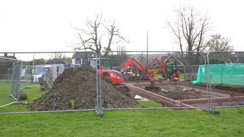 The start of a construction project, a digger is digging the foundations 動画素材 188504644