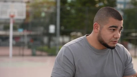 Start the Day Strong: Guy's Shadowboxing on Palm-Covered Basketball Court Stock Footage 243170202