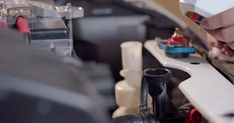 Start the engine and fill blue radiator water.Adding Coolant to Car. Stock Footage 277843386