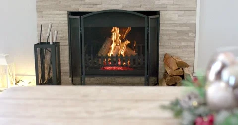At start fire burning in metal grate on hearth, logs flickering, shrinking Video stock 340069076