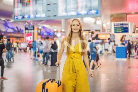 Start of her journey. Beautiful young woman ltraveler in a yellow dress and a Stock Photos