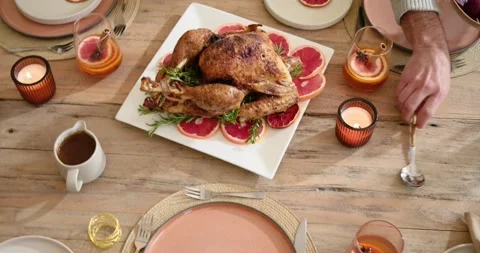 At start host is arranging settings while roast is moving to center on table for Stock Footage 344402662