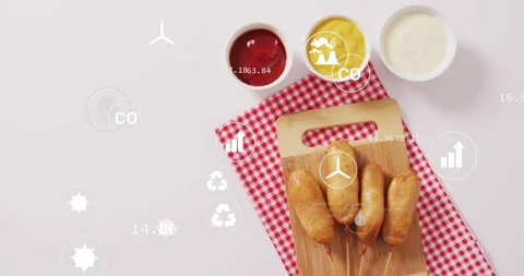 On start, infographic icons drifting, clustering over corn dogs and sauces, Stock Footage 333975238