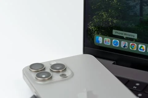 Start Iphone mirroring feature on macbook pro Stock Photos