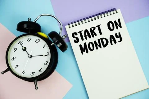 Start On Monday text written on notepad with alarm clock flat lay on multic.. Stock Photos