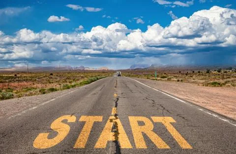 Start, new beginning concept. Text sign on a long straight highway in the ame Stock Photos