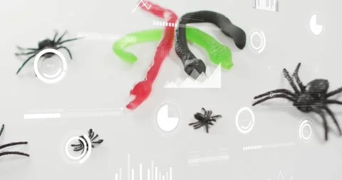 On start overlays sliding and rotating over rubber snake, gummy worms and Video stock 317791829