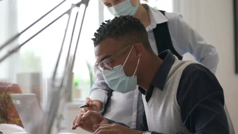 Start-up people working in co-working space office, wearing face mask during 19- Stock Footage 146574829
