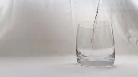 The Start of Pouring Pure Water, Macro Shot of a Droplet Falling, Slow Motion Stock Footage 318664210