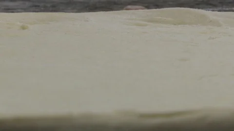 Start preparing pizza - putting tomato sauce on the dough 库存影片 123650240