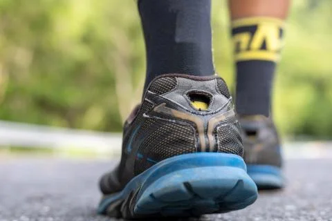 Start to run concept. Man runner feet on road in Park workout wellness soft f 스톡 사진