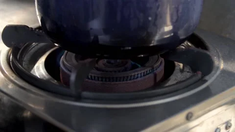 Start sequence of gas stove with blue saucepan heated by blue and orange flame Stock Footage 159004272