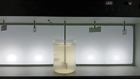 Start of Slow Mixing Process in Jar Test - First Stage of Flocculation Video stock 326168230