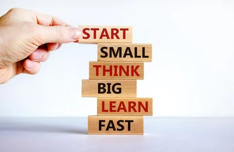 Start small think big symbol. Words 'Start small think big learn fast' on woo Stock Photos