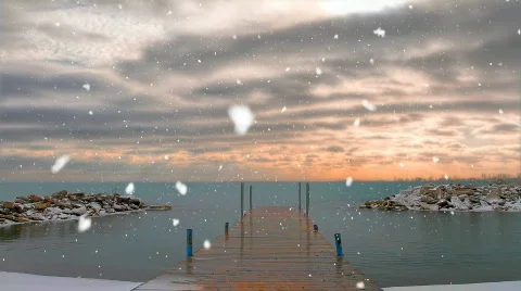 Start of Snow Fall with sunset over lake with dock Stock Footage 643190