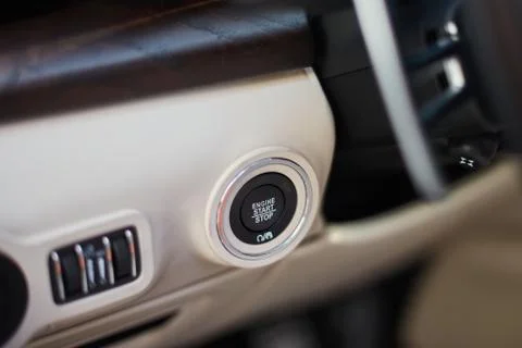 A Start-stop button to start the engine in a luxury car. Stock Photos