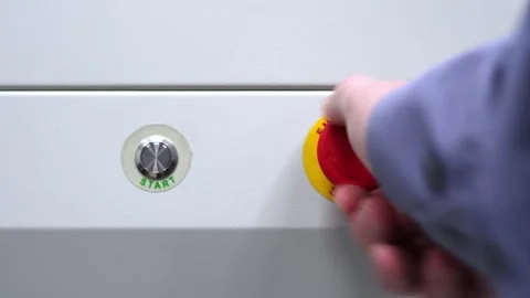 Start stop buttons. The man is pushing buttons. Industrial equipment setup. Stock Footage 296109172