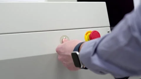 Start stop buttons. The man is pushing buttons. Industrial equipment setup. Stock Footage 296109218