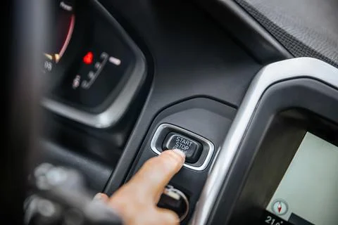 Start stop engine button, car driver starting the car Stock Photos