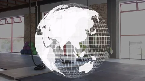 On start translucent wireframe globe rotating Africa-to-Americas over gym, Stock Footage 333287708