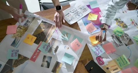 On start two hands are sketching arrows and arranging sticky notes on wooden Stock Footage 341467601
