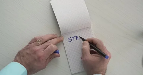 Start  - this word is written on the sheet by a man's hand Stock Footage 267084178