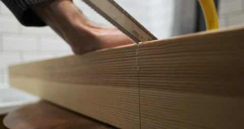 Start of work hand saw saws thick square wooden beam, side view, close-up Stock Footage 256249195