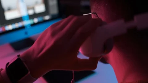 Start of work on new project at home office. Bearded student puts on headphones Stock Footage 126847277