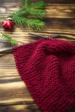 Started knitting on knitting needles, with yarn on a rustic wooden table, with Stock Photos